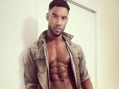 Ernest Pierce is wearing a shirt that isn't bottoned thus, showing his six pack abs.